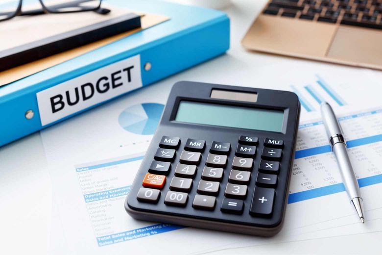 budget folder and calculator on a desk